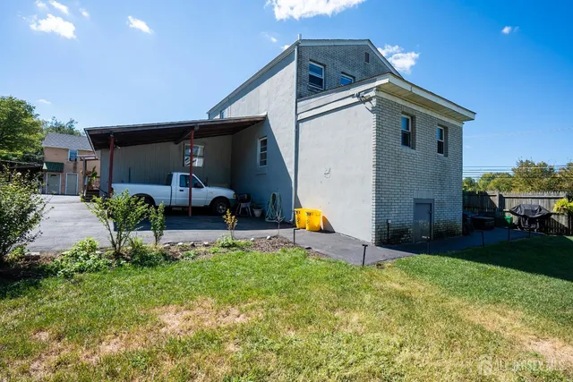 a view of a chair and table in backyard of the house