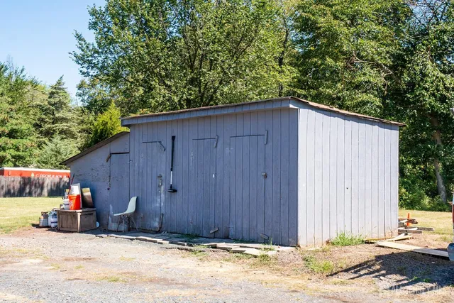 a backyard of a house with bicycles parked in front of it
