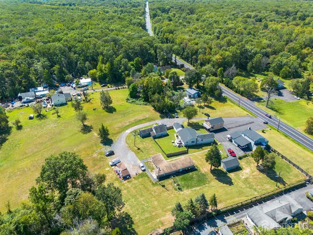 an aerial view of residential houses with outdoor space and swimming pool