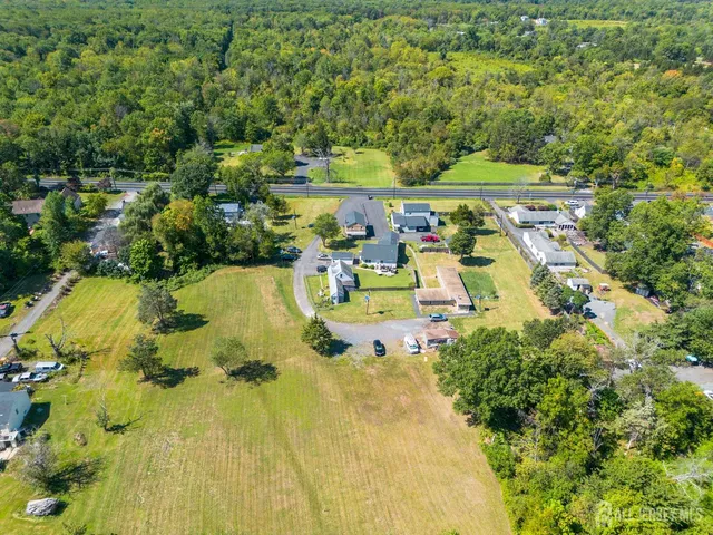 an aerial view of a swimming pool with a yard
