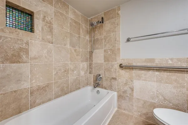 a bathroom with a bathtub and shower
