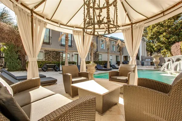 a view of a patio with couches and table with garden view