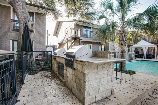 a view of a patio with iron fence