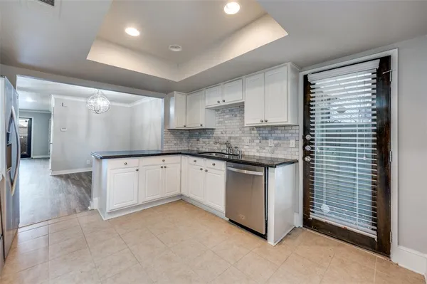 a kitchen with granite countertop white cabinets and white appliances