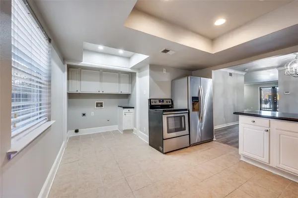 a kitchen with cabinets and stainless steel appliances