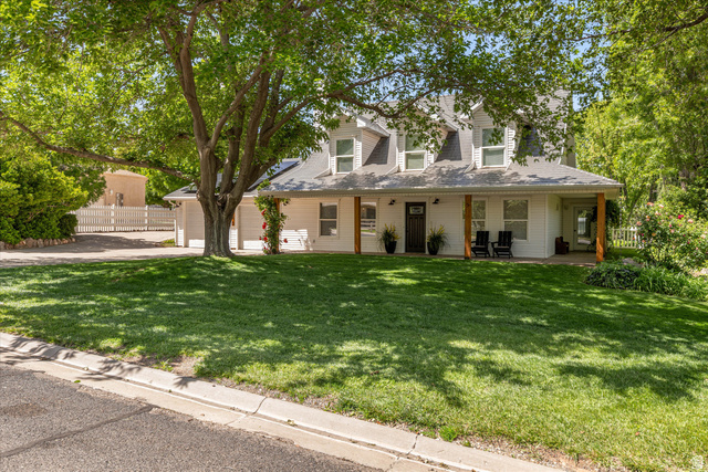 246 West Mount Charm Road Toquerville, UT 84774 - Photo 2 of 70 Cape cod house with concrete driveway, a porch, and a garage