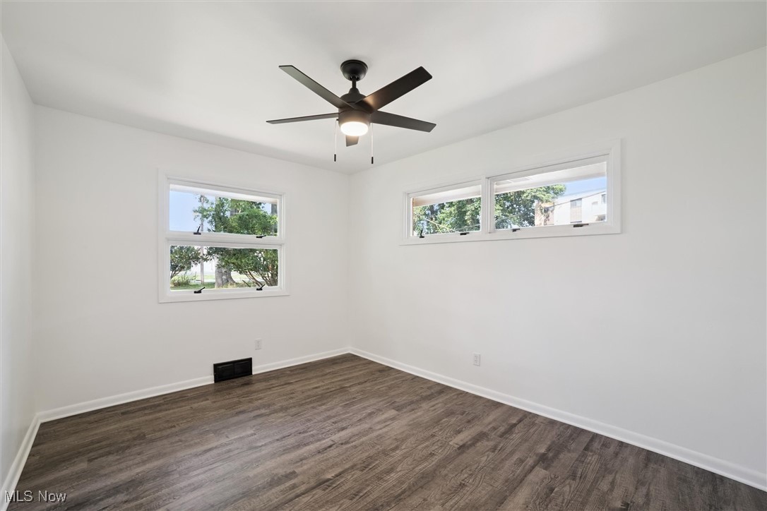 12241 Huffman Road Cleveland, OH 44130 - Photo 21 of 43 Empty room featuring dark wood-style floors and ceiling fan
