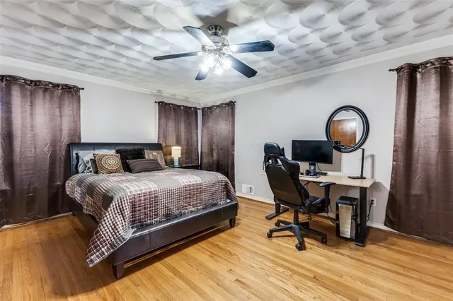 a bedroom with a bed a desk and chair