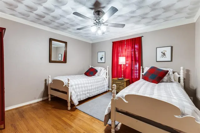 a bedroom with two beds and a chandelier