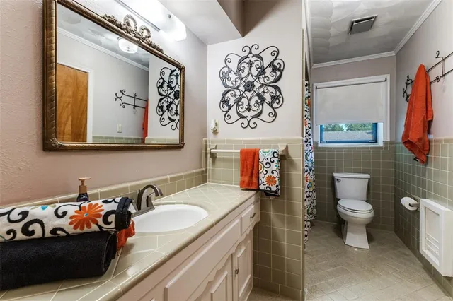 a bathroom with a sink and mirror with toilet