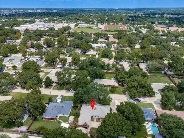 an aerial view of residential house and car parked