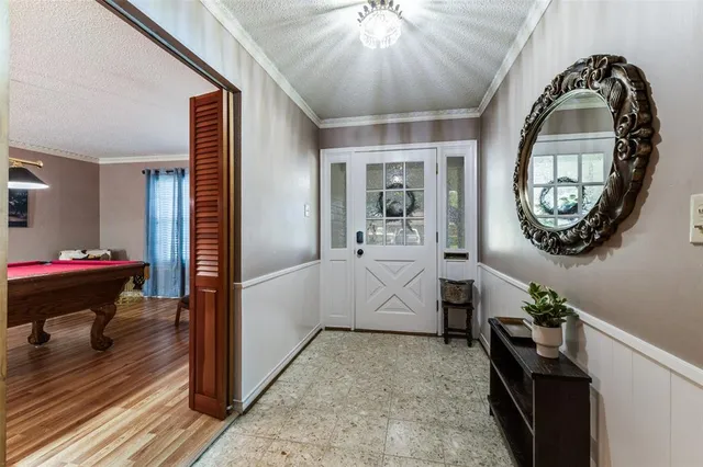 a view of an entryway with wooden floor