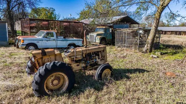 a view of roof deck with table and chairs
