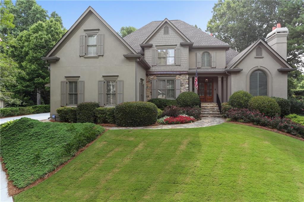 509 Reston Mill Lane Southeast Marietta, GA 30067 - Photo 1 of 1 a front view of a house with a yard and garage