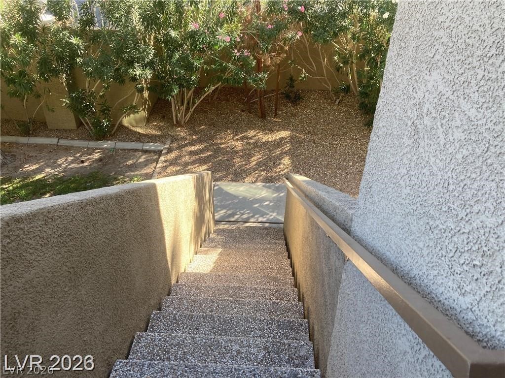 3145 East Flamingo Road, Unit 2100 Las Vegas, NV 89121 - Photo 3 of 34 Descend into a private yard space, bordered by mature plantings for serene outdoor living.