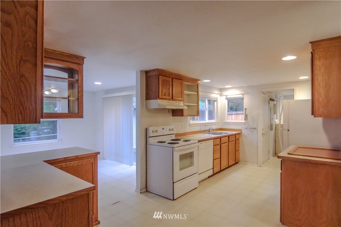 22028 9th Avenue Southeast Bothell, WA 98021 - Photo 12 of 16 a kitchen with stainless steel appliances granite countertop a stove a sink and a refrigerator