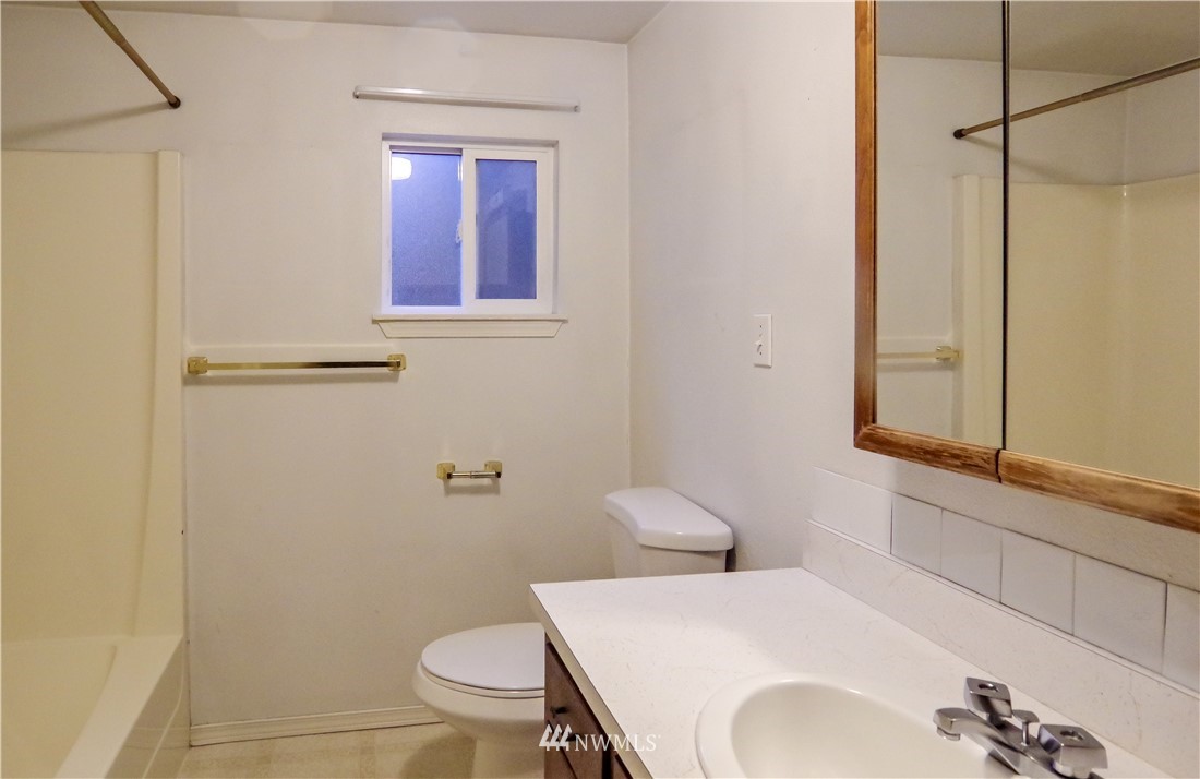 22028 9th Avenue Southeast Bothell, WA 98021 - Photo 14 of 16 a bathroom with a sink and mirror with toilet