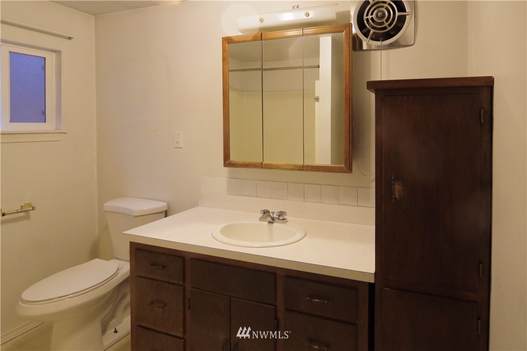 22028 9th Avenue Southeast Bothell, WA 98021 - Photo 15 of 16 a bathroom with a sink a toilet and a mirror