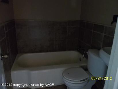 4600 South Travis Street Amarillo, TX 79110 - Photo 2 of 3 a bathroom with a toilet and a bathtub