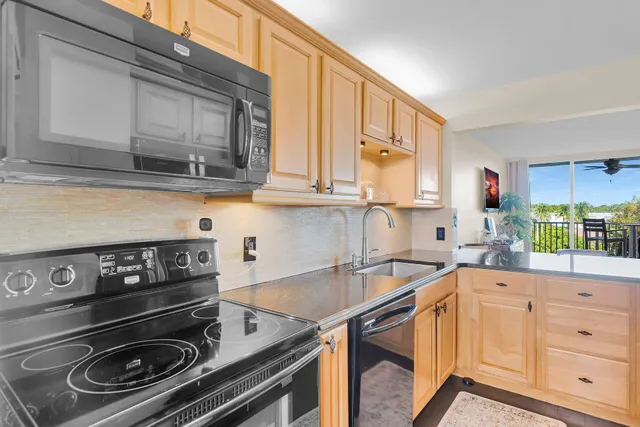a kitchen with a stove microwave and sink