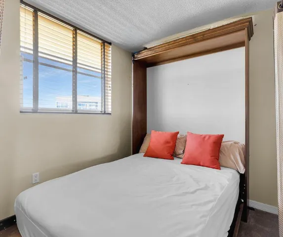 a bedroom with a large bed and a large window