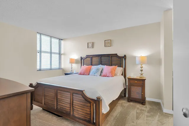 a bedroom with a bed and a night stand