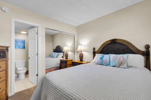 a bedroom with a bed and a lamp