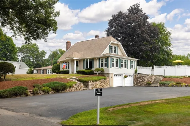 a front view of a house with a yard street and trees