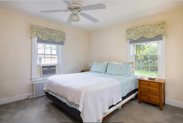 a bedroom with a bed and window