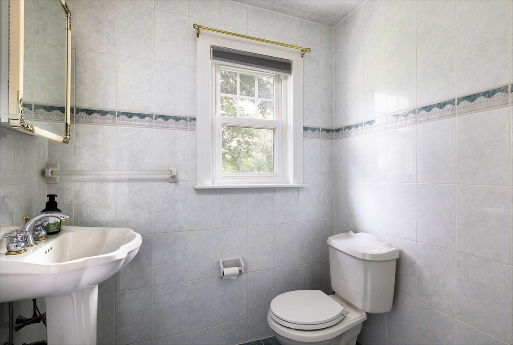 30 Olive Street Ashland, MA 01721 - Photo 7 of 9 a bathroom with a sink a mirror and a toilet