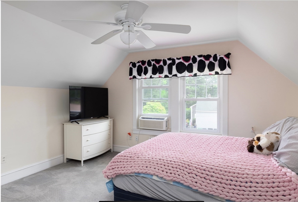 30 Olive Street Ashland, MA 01721 - Photo 9 of 9 a bedroom with a bed and a flat tv screen on the dresser