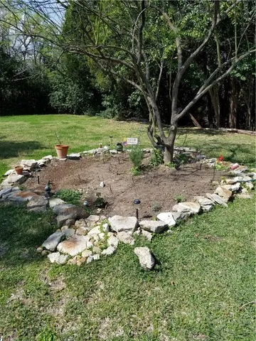 a backyard of a house with a yard and outdoor seating