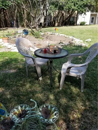 a backyard of a house with table and chairs