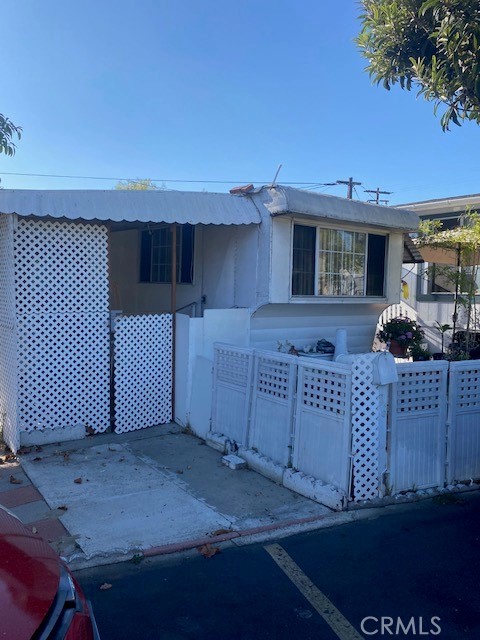 2767 West 1st Street, Unit 26 Santa Ana, CA 92703 - Photo 2 of 15 a view of a house with a wooden fence