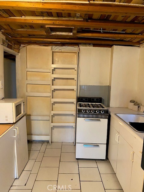 2767 West 1st Street, Unit 26 Santa Ana, CA 92703 - Photo 5 of 15 a kitchen with a stove and a refrigerator