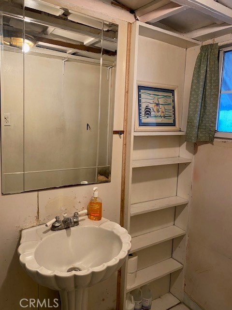 2767 West 1st Street, Unit 26 Santa Ana, CA 92703 - Photo 9 of 15 a bathroom with a sink and mirror with toilet