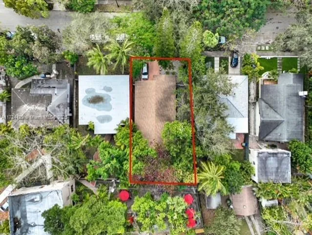 an aerial view of a house with a yard and garden