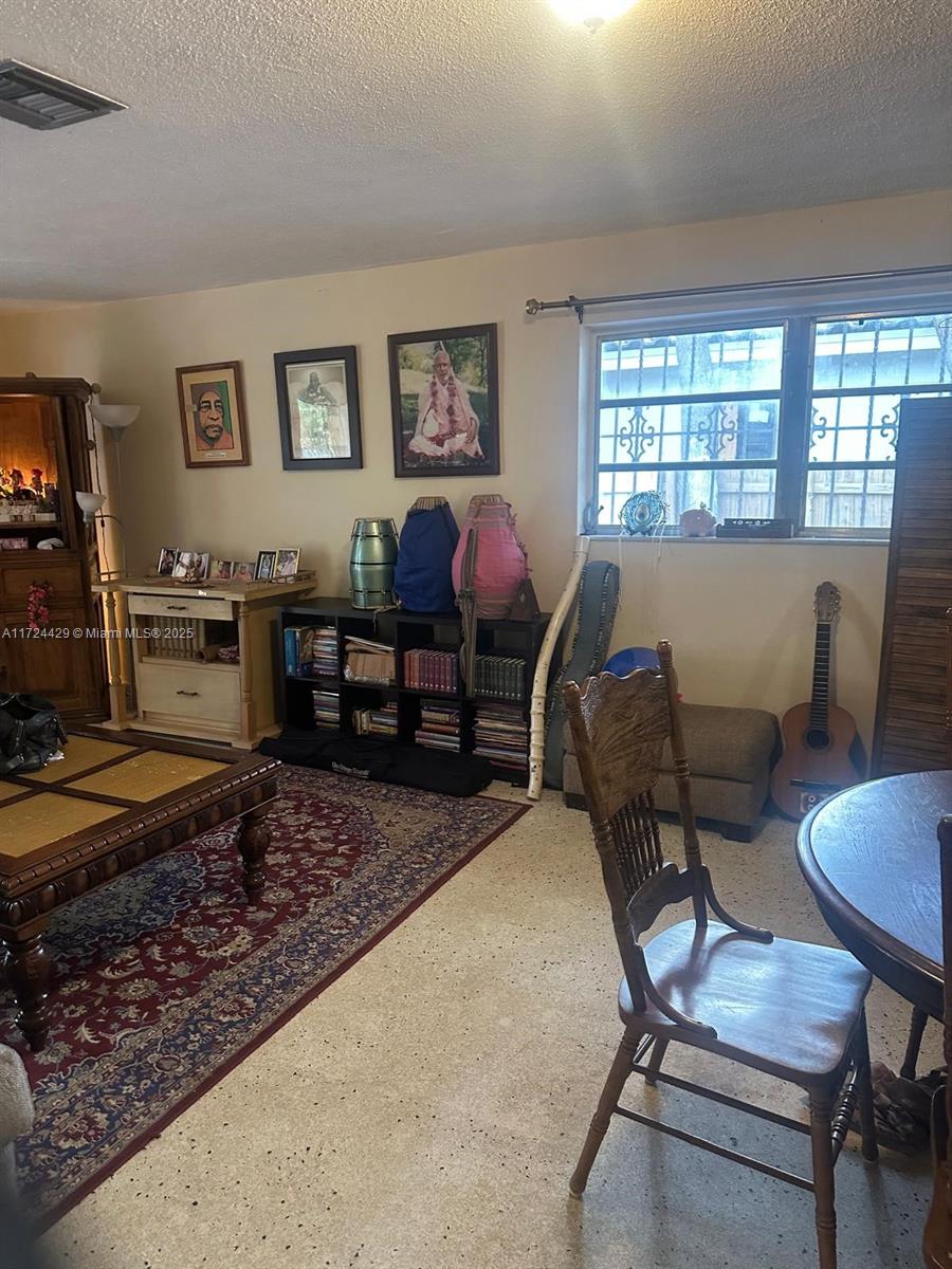 133 Northeast 48th Street Miami, FL 33137 - Photo 9 of 32 a living room with furniture and a window