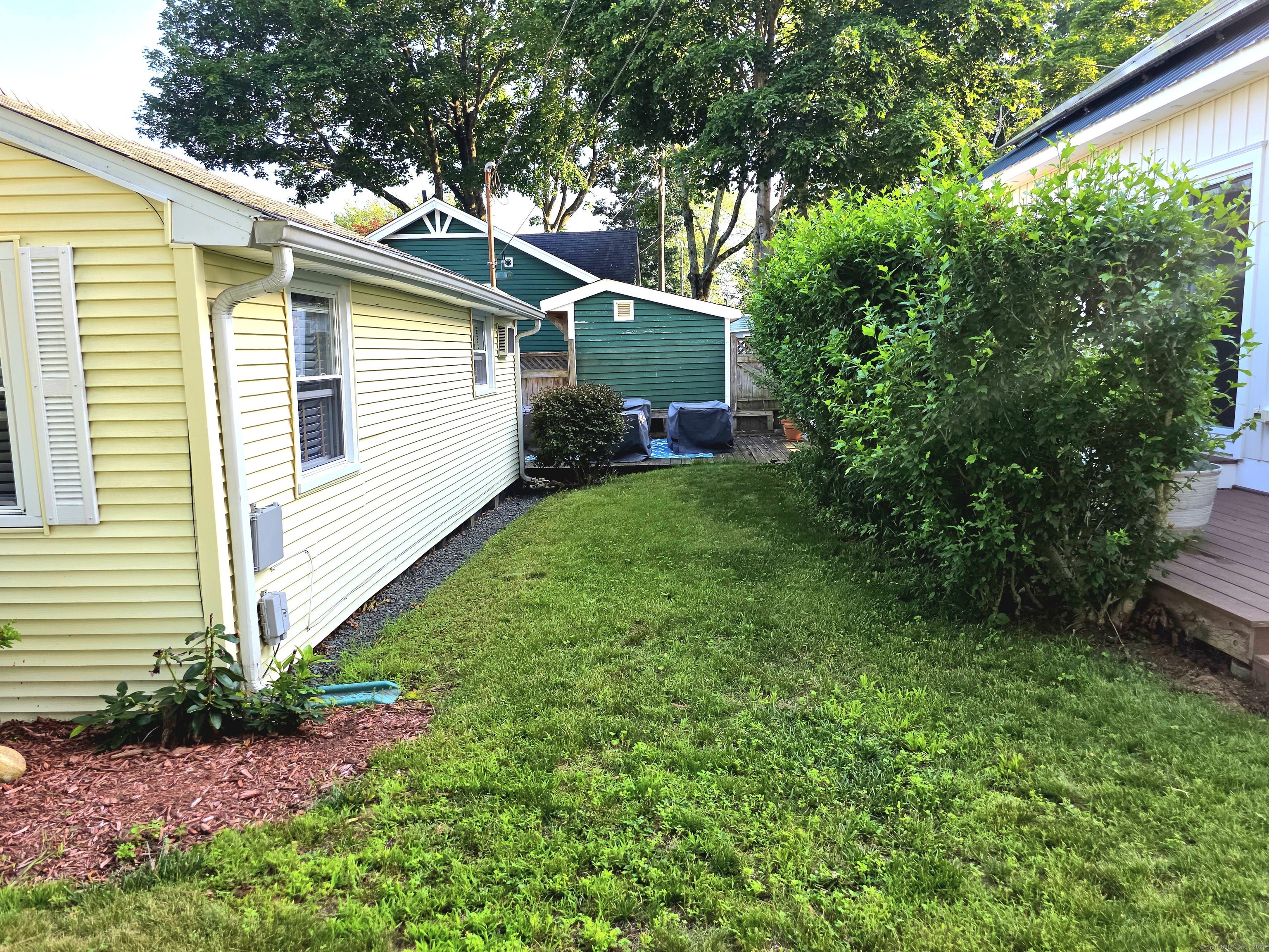 7 3rd Street Madison, CT 06443 - Photo 21 of 23 a view of a house with a yard plants and large tree