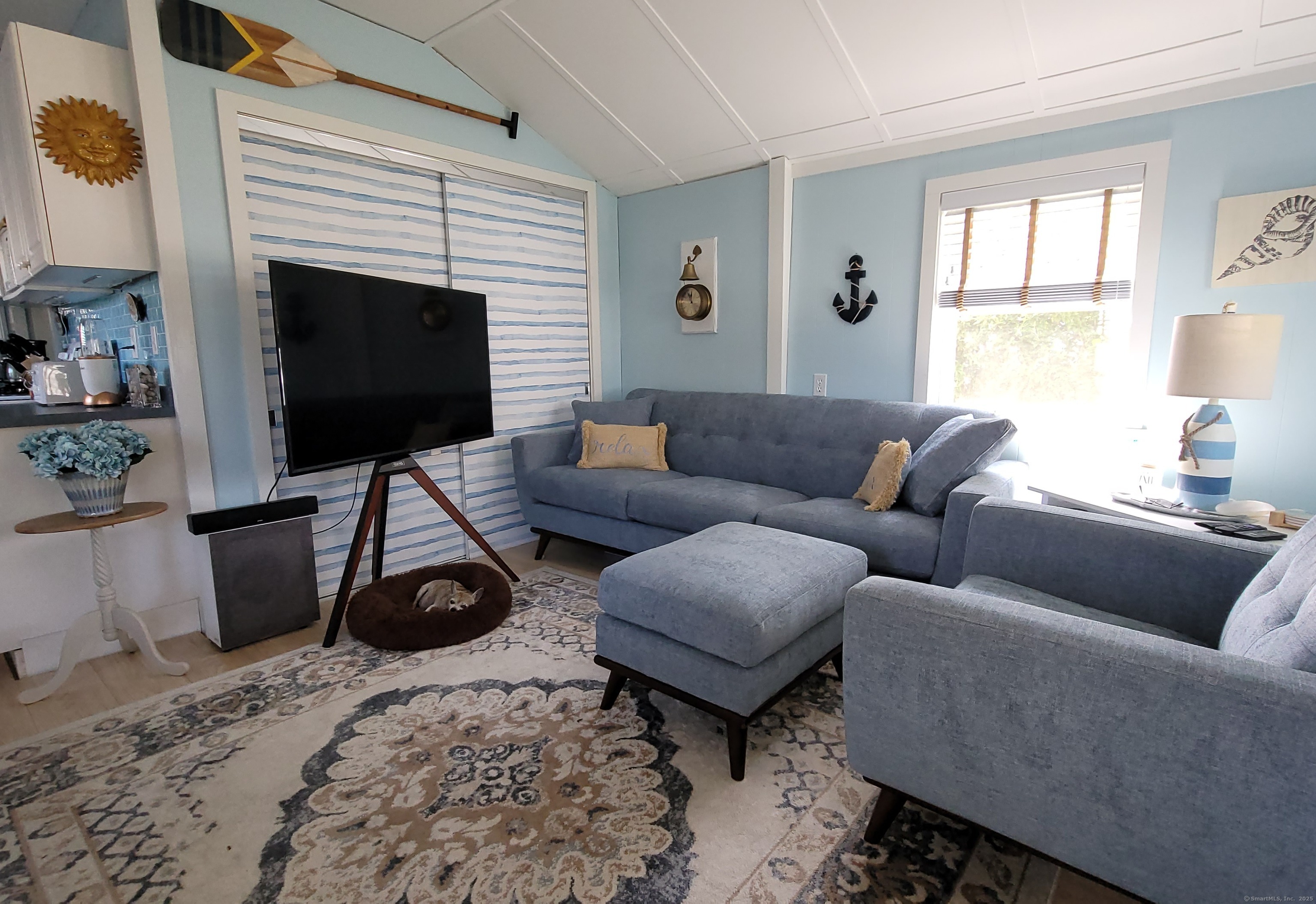7 3rd Street Madison, CT 06443 - Photo 5 of 23 a living room with furniture a flat screen tv and a fireplace