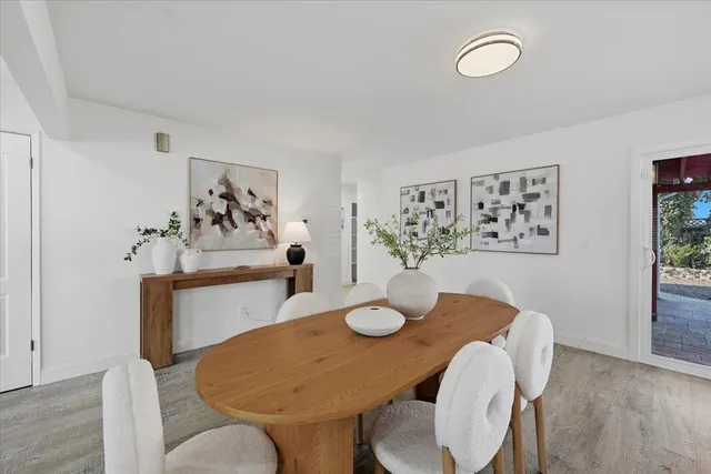 a kitchen that has a lot of cabinets and stainless steel appliances