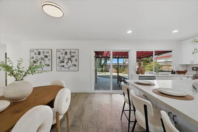 a kitchen with stainless steel appliances granite countertop a sink a stove and a refrigerator