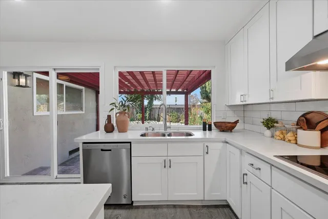 a kitchen with stainless steel appliances kitchen island granite countertop a kitchen island a stove a table and chairs