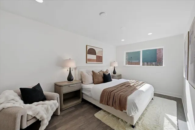 a bedroom with a bed and a painting on the wall