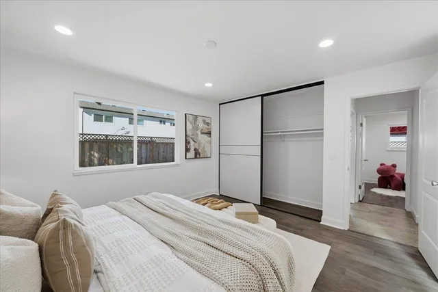 a bedroom with a bed and a painting on the wall