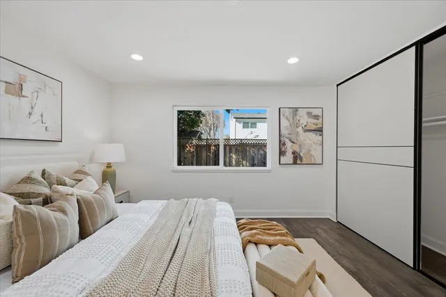 a bedroom with a bed and a painting on the wall