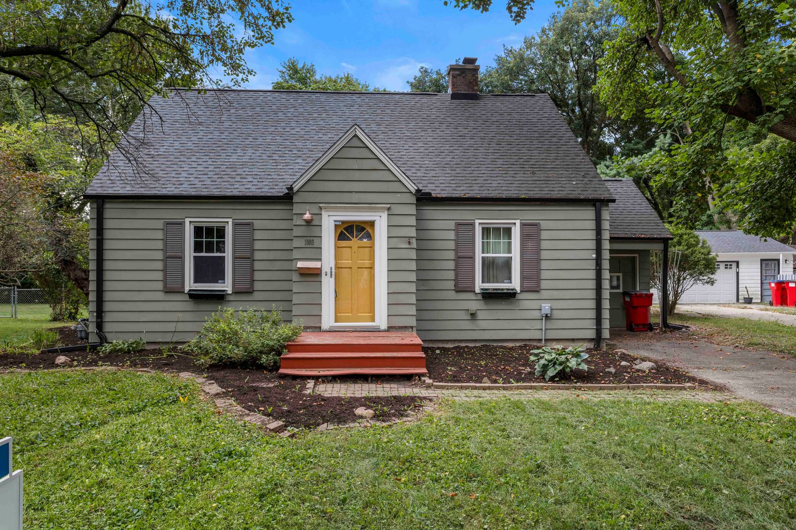 1009 West Columbia Avenue Champaign, IL 61821 - Photo 1 of 10 a front view of house with yard and trees