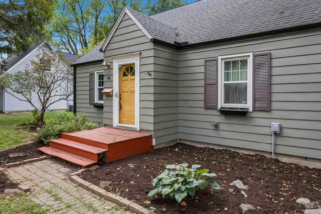a view of a house with a yard and sitting area