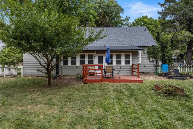 a view of a house with swimming pool and sitting area