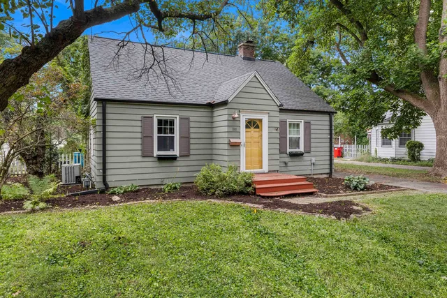 a front view of a house with garden